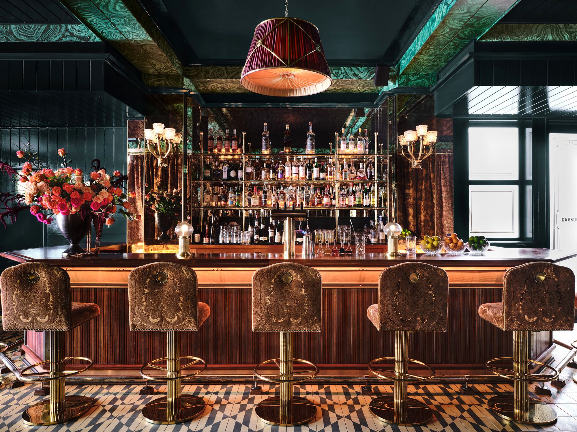 Glass and mirror surrounding one of Carbone’s two bars