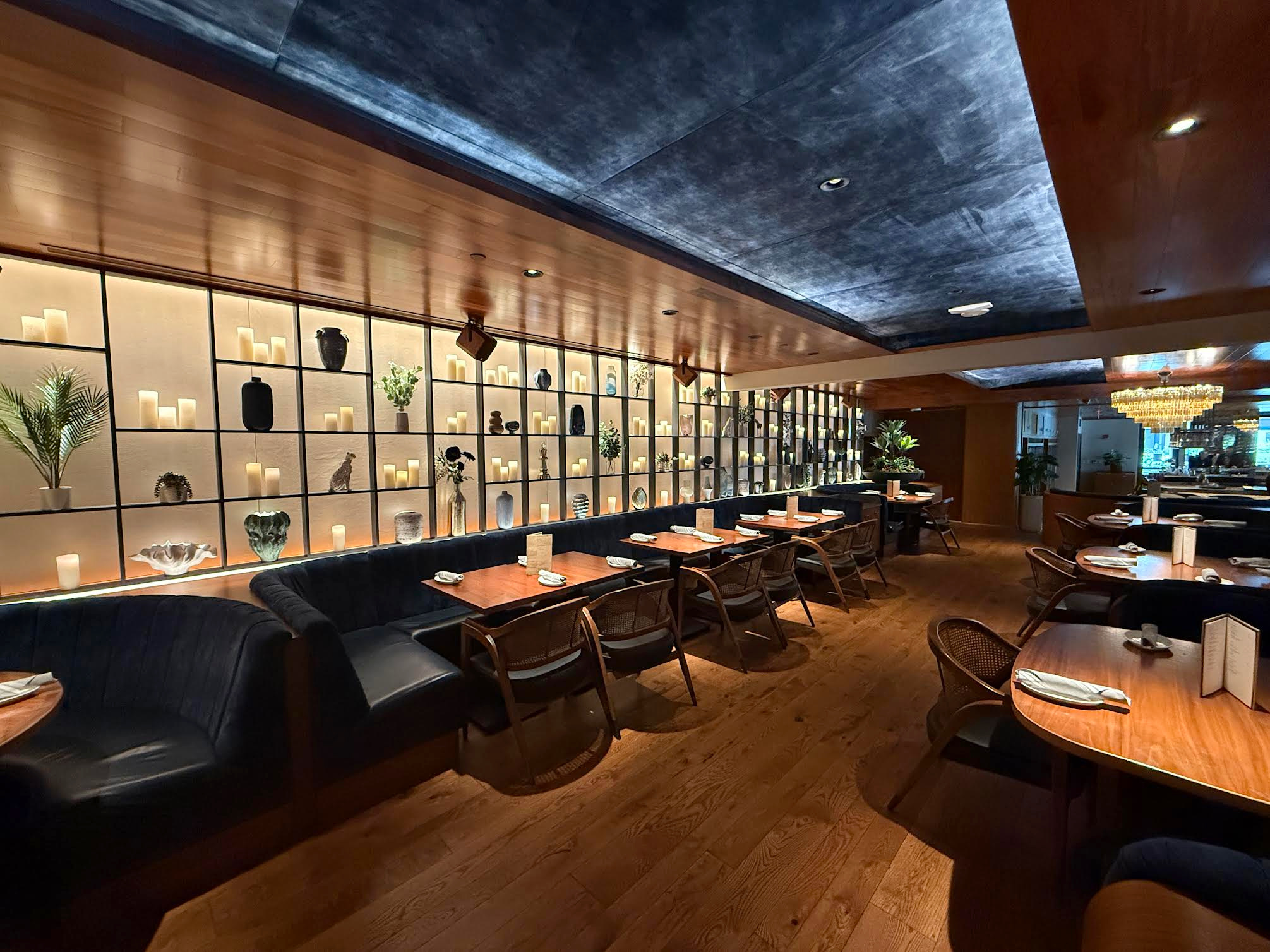 Illuminated shelving and warm wood finishes at Chop Steakhouse