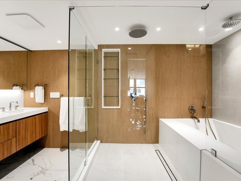 Clear shower enclosure beside the tub at The Towers VI